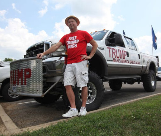 Mark Hoffman posing with his truck covered in Trump regalia