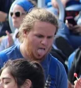 Seth in a marching band uniform with his tongue sticking out