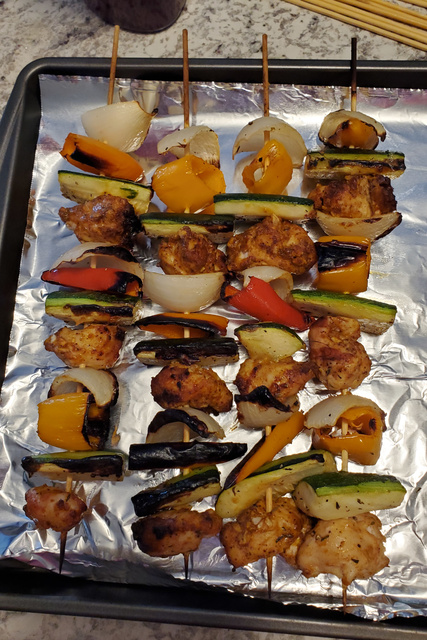 Kebabs on a foil-lined baking sheet